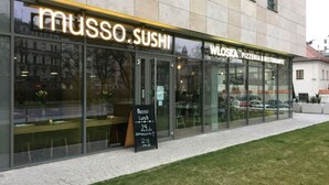A building with a 'MUSSO SUSHI' sign and a 'WELSKA PIZZERIA & RESTORANTE' sign. There's a blackboard with 'MUSSO Lunch' and pricing information. - Modern lux flat( studio) by Wawel Castle  (Krakow)