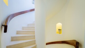 A staircase with a wooden handrail and a small illuminated alcove. - Top renovated townhouse with pool and sea access (Porches)