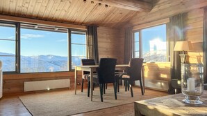 A cozy room with wooden walls and a large window offering a mountain view. - 3 bedroom amazing home in Uvdal (Uvdal)