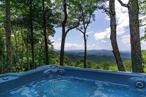 A hot tub surrounded by trees with a view of a mountainous landscape. - September Special | Hot Tub+Breathtaking Mtn Views (Spruce Pine)