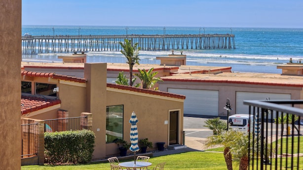 A beachfront property with a view of the ocean and a pier. - 110 Pismo Shores: 2  BR, 1.5  BA Condominium in Pismo Beach, Sleeps 6 (Pismo Beach)