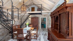 A rustic interior with a dining area, wooden staircase, and a decorative cabinet. - Awesome home in Omis with house a mountain view (Omis)