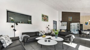 Ein modernes Wohnzimmer mit zwei Sofas, einem Couchtisch und einem Kamin.