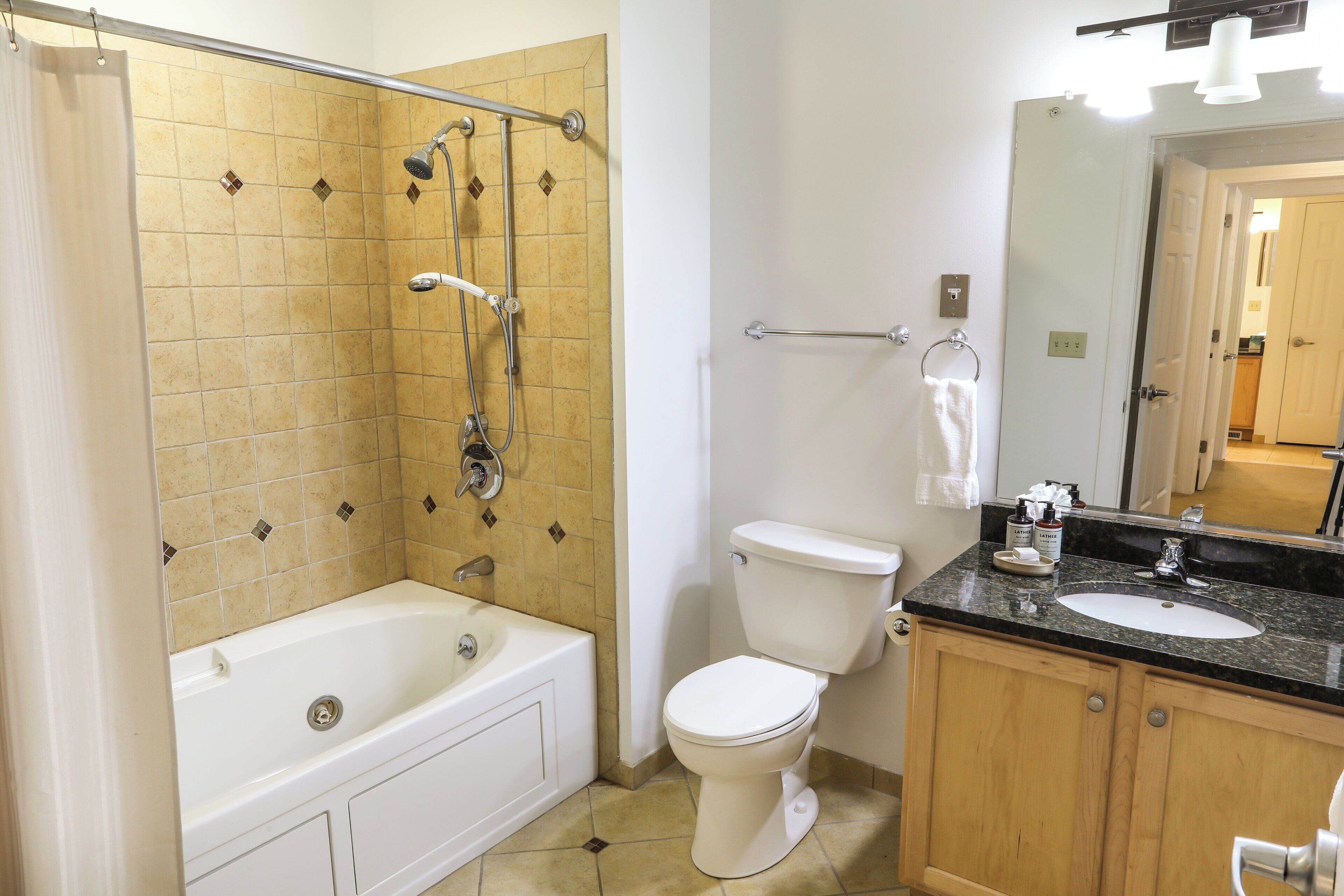 A bathroom with a bathtub, toilet, and sink.
