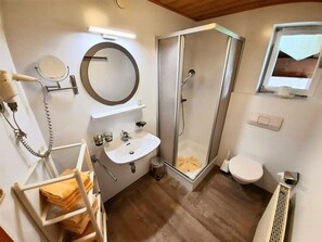 Shower, hair dryer, towels, toilet paper