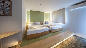 A modern hotel room with two beds, a large window, and a green accent wall. - Grand Base Okayama Ekimae (Okayama)