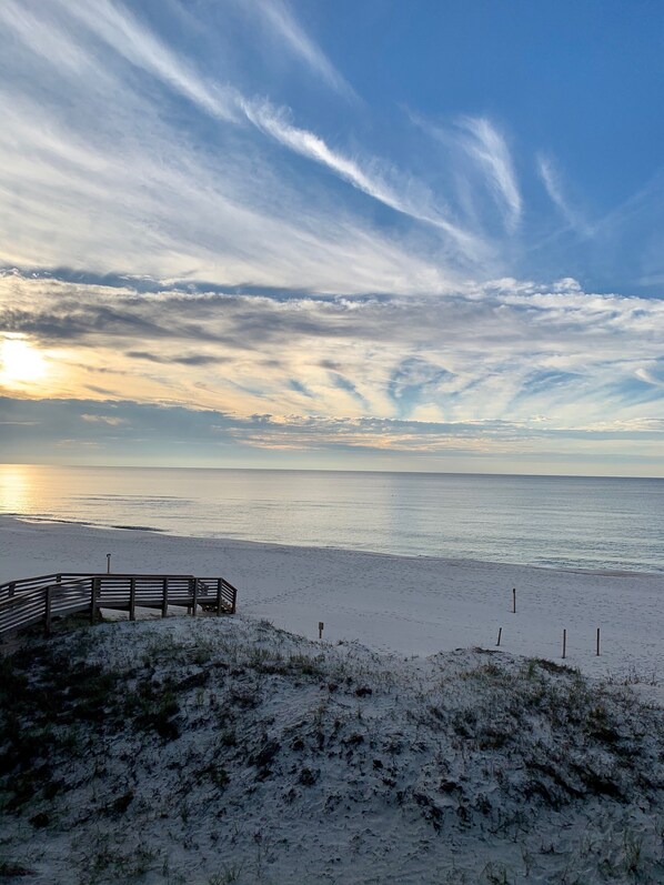 A beach with a wooden walkway leading to a bench, overlooking the ocean. - Beautiful Beachfront Haven! (Pensacola)