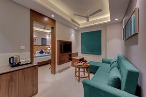 Luxury Room | Living area | 32-inch LCD TV with cable channels, TV