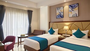 A hotel room with two beds, a desk, a chair, and a window with curtains. - Click Hotel Aurangabad (Chhatrapati Sambhajinagar)