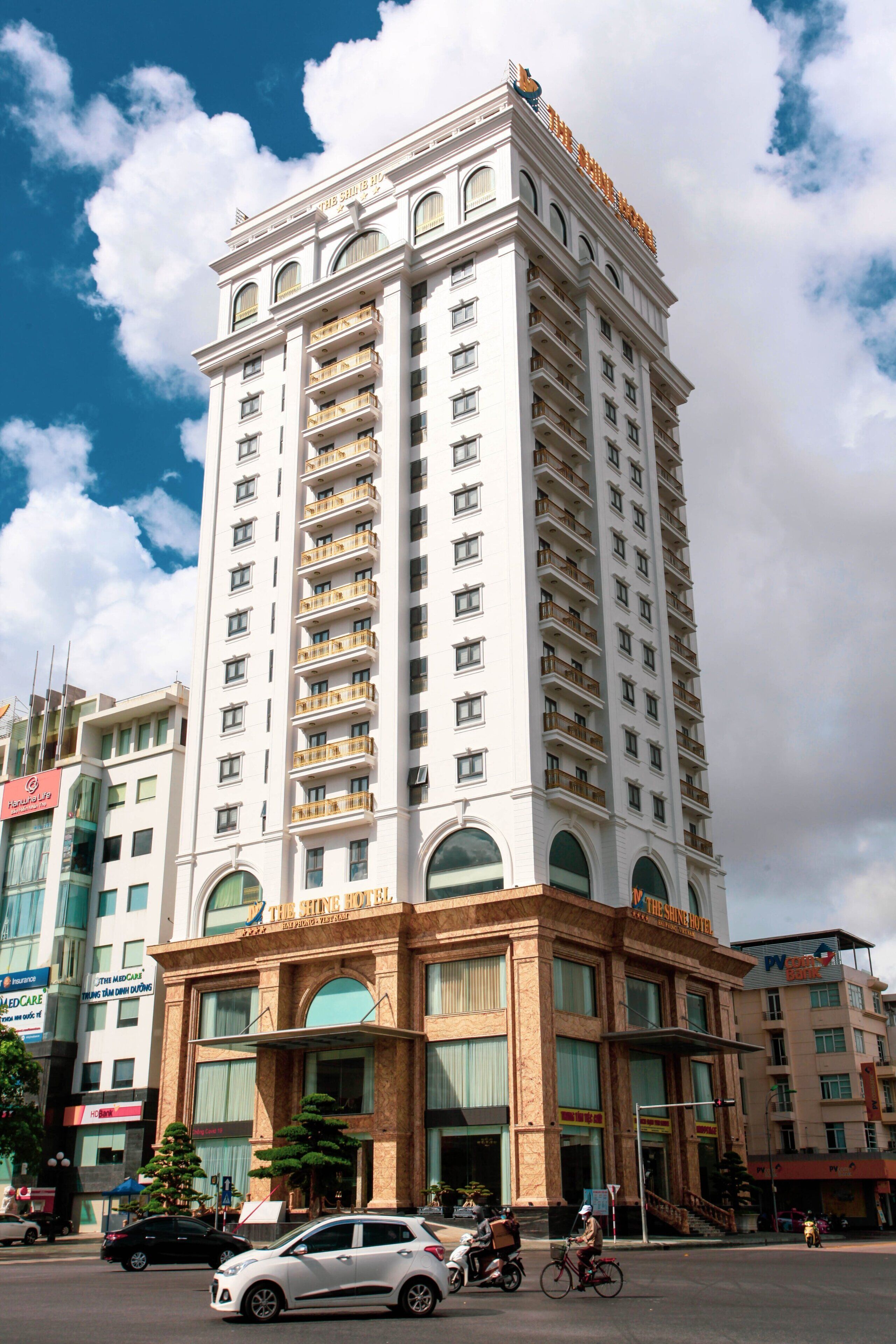 A tall, multi-story hotel with a prominent entrance and balconies.