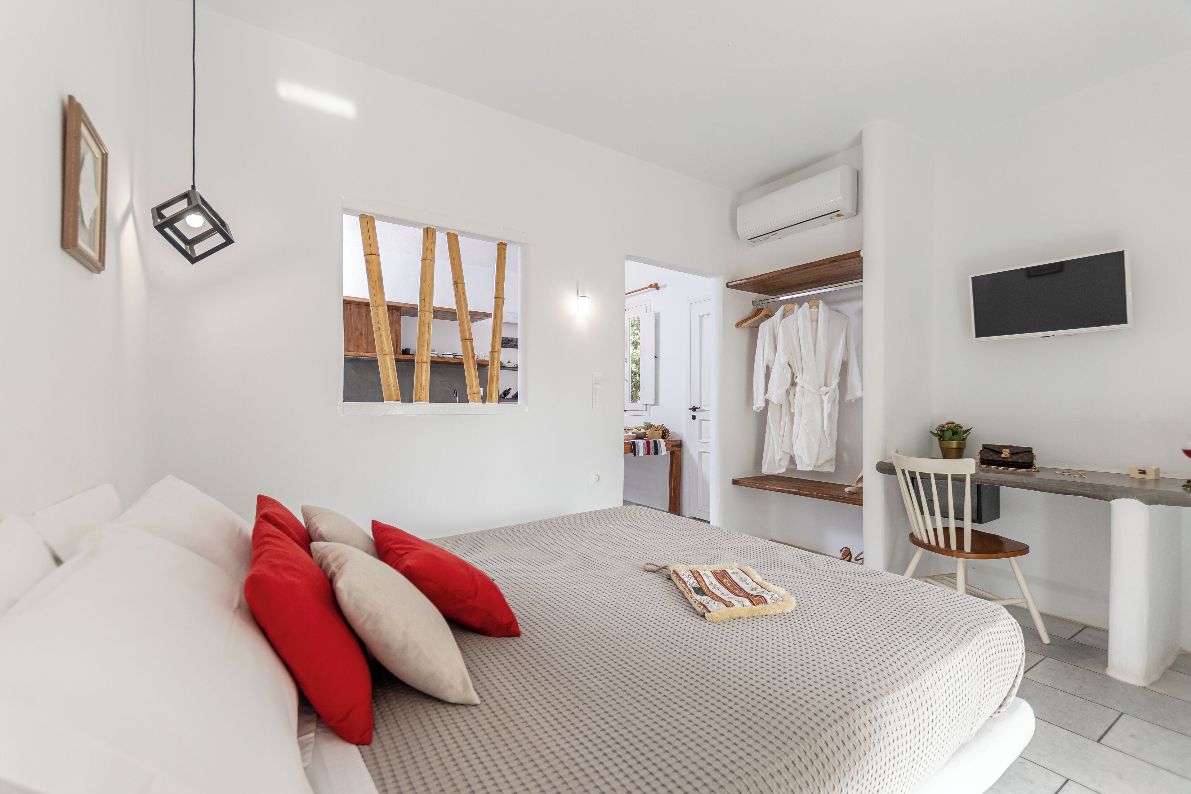 A modern bedroom with a bed, a desk, and a chair.