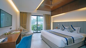 A hotel room with a bed, desk, chair, and a balcony with curtains. - Dream Square Resort (Sreepur)