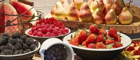 A variety of fresh fruits including watermelon, raspberries, blueberries, strawberries, and pears.