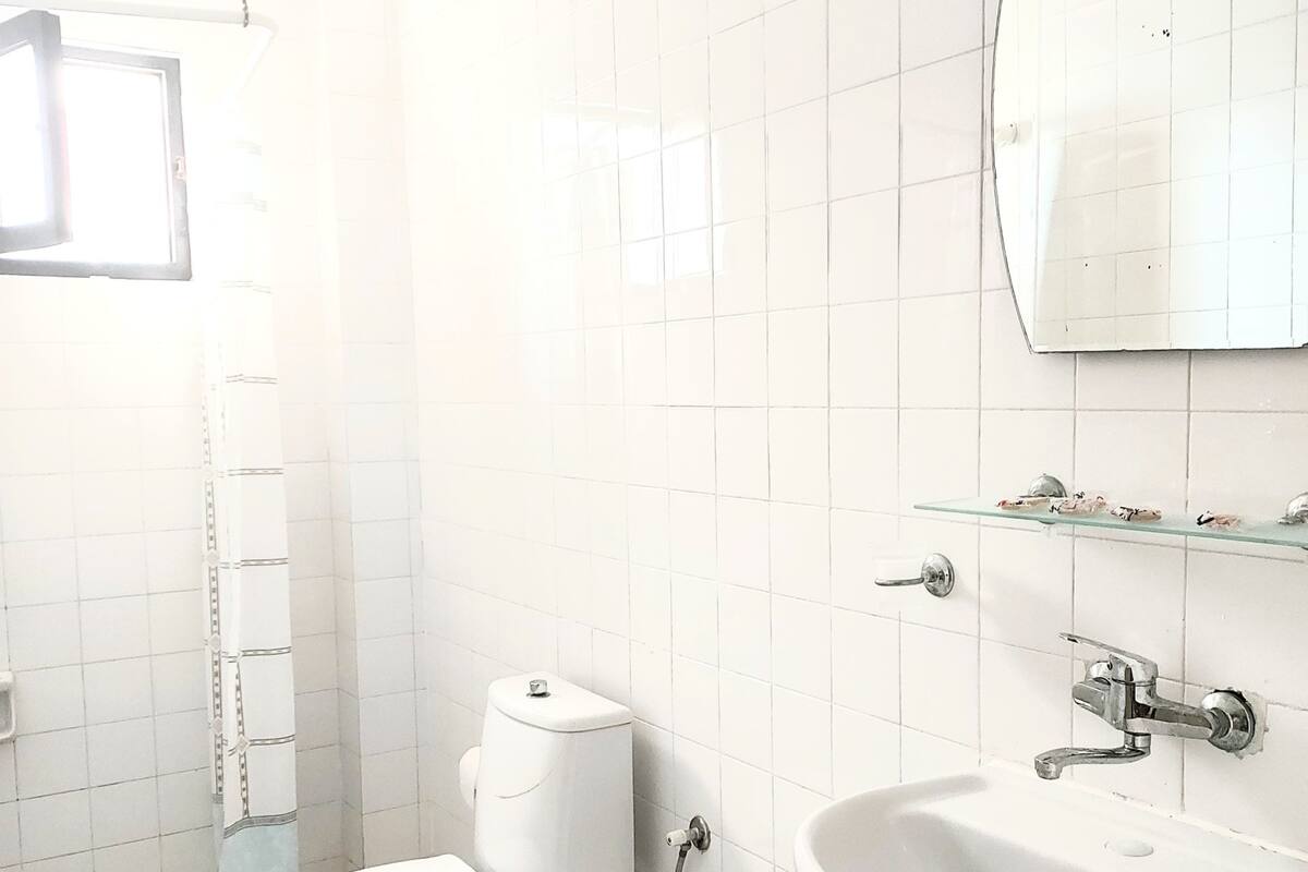 A modern bathroom with a toilet, bidet, and sink.