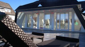 A modern building with a sloped roof and large glass doors. - Luxus Apartment Pasha im Rheingau (Geisenheim)
