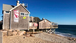 A coastal building with a sign for 'Ocean Mist' and another for 'Harpoon'.