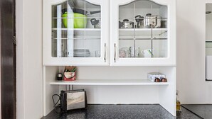 A kitchen with white cabinets, a black countertop, and various kitchen items. - Modern Apartment in The Heart of Vienna 2 (Vienna)