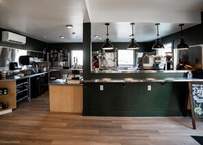 A modern kitchen with a central island, stainless steel appliances, and pendant lighting. - LOGE Leavenworth (Leavenworth)