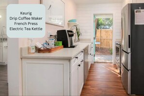 A kitchen with a kettle, coffee maker, and French press on the counter. - Unbeatable Location - Beaches & DT - Kid Friendly (Mount Pleasant)