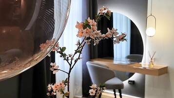 A modern interior with a curved mirror, a desk, and a chair.