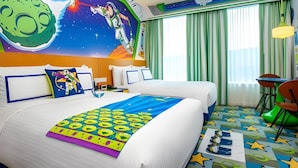 A hotel room with two beds, a mural of a space scene, a large window with green curtains, and a colorful star-patterned carpet. - Toy Story Hotel (Shanghai)