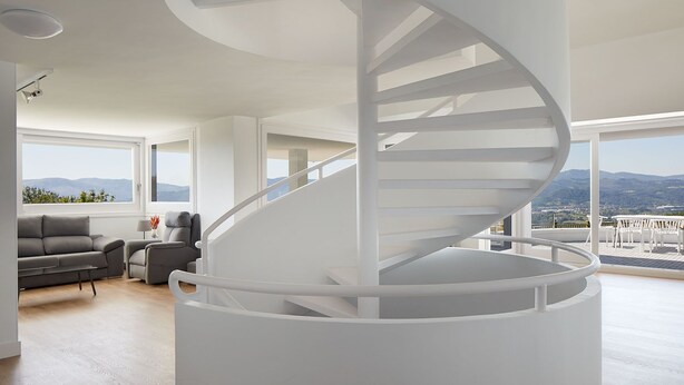 A modern interior with a spiral staircase, a sofa, and a view of the outdoors. - BASQUE BREATH-Unique Villa, Fantastic View, Fabulous Pool (hondarribia)