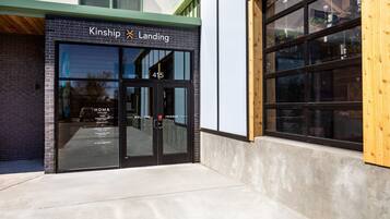 A building entrance with a sign reading "Kinship Landing" and the number 415.