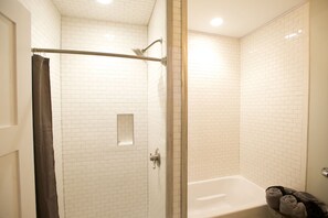 Bathtub, eco-friendly toiletries, hair dryer, towels