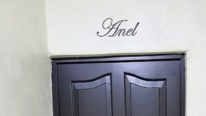 A black door with a nameplate above it.
