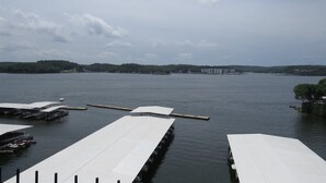 A marina with multiple docked boats and a large building in the background.