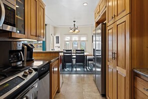 Enjoy cooking in this well-equipped kitchen with oven, microwave, coffee maker, and refrigerator.