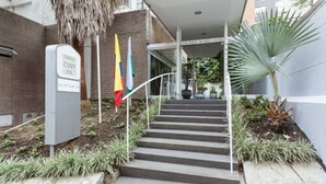 A staircase leading to a building entrance with a sign reading "Cyan Hotel." - Loslan Real Estate (Medellín)