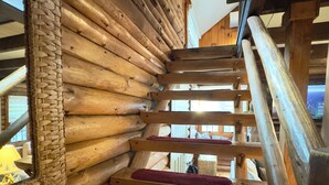 A wooden staircase with red carpeted steps leading to a higher level. - Lakefront Cabin w/ Hot Tub, Views & Fireplace (Lake Harmony)