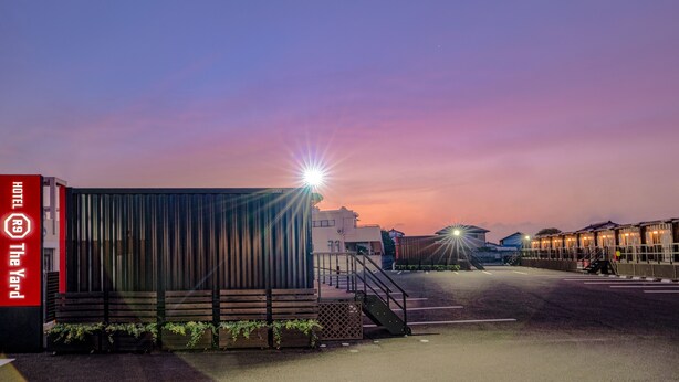 A hotel entrance with a modern design, a visible staircase, and a well-lit pathway leading to the building. - HOTEL R9 The Yard Isezaki (Isesaki)
