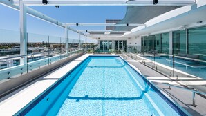 A rooftop swimming pool with glass railings and a clear view of the cityscape. - Vibe Hotel Subiaco Perth (Subiaco)