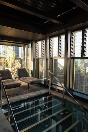 Indoor pool, pool loungers. Quincy Hotel Melbourne