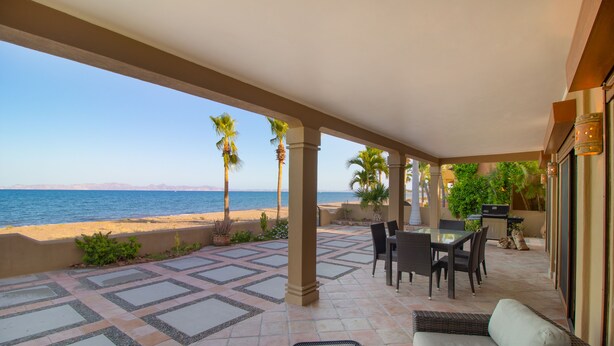 A covered patio with a view of the beach, outdoor furniture, and a grill area. - Rare Beachfront Steps to Sand/Paddleboards and Bikes  (Loreto)
