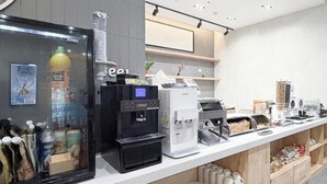 A modern coffee station with multiple coffee machines and a refrigerated display case. - Brown Dot Hotel Busan Sajik Stadium (Busan)