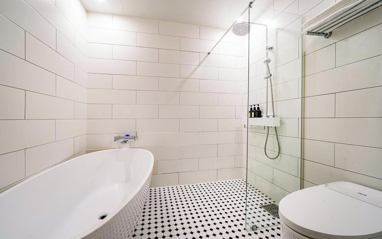 Ein Badezimmer mit Badewanne, Dusche und Toilette.