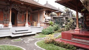 A traditional Balinese temple complex with ornate architecture, including tiered roofs and intricate carvings. - Ramaya House (Tegallalang)