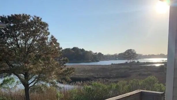 A wooden deck with a view of a lake and marshland. - beach. Ocean view. Townhouse (Norfolk)