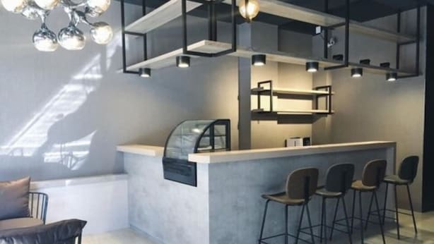 A modern bar area with a counter, bar stools, and pendant lighting. - Meet 57 Homestay (Zhuqi)