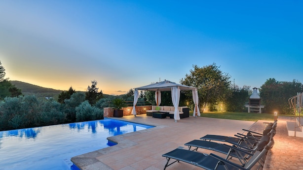A swimming pool with lounge chairs and a gazebo. - CASA FENIX (Sant Josep de Sa Talaia / San Jose)