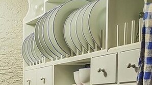 A kitchen with white cabinets, a blue sugar container, and various kitchenware. - Grashöfle (Sankt Oswald-Riedlhuette)