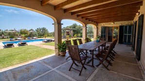 A covered patio with a pool, outdoor seating, and a view of the pool area. - Vela 1 Finca for 8 with pool in Playas de Muro (Muro)