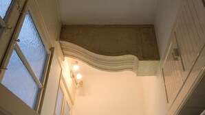 A corner of a room with a white wall, a window, and a light fixture. - Extremely central 2 BR Apartment next to St  Stephen Cathedral (Vienna)