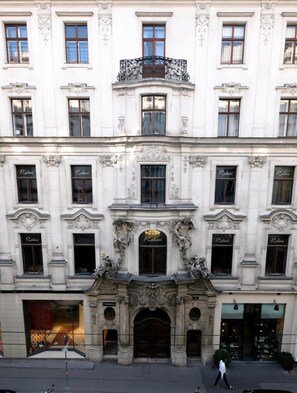 A historic building with ornate architectural details, including a central entrance with a decorative arch and statues, and multiple windows with the name "Rahimi" displayed.