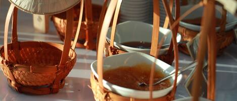 A table with woven baskets and bowls, likely for serving food.
