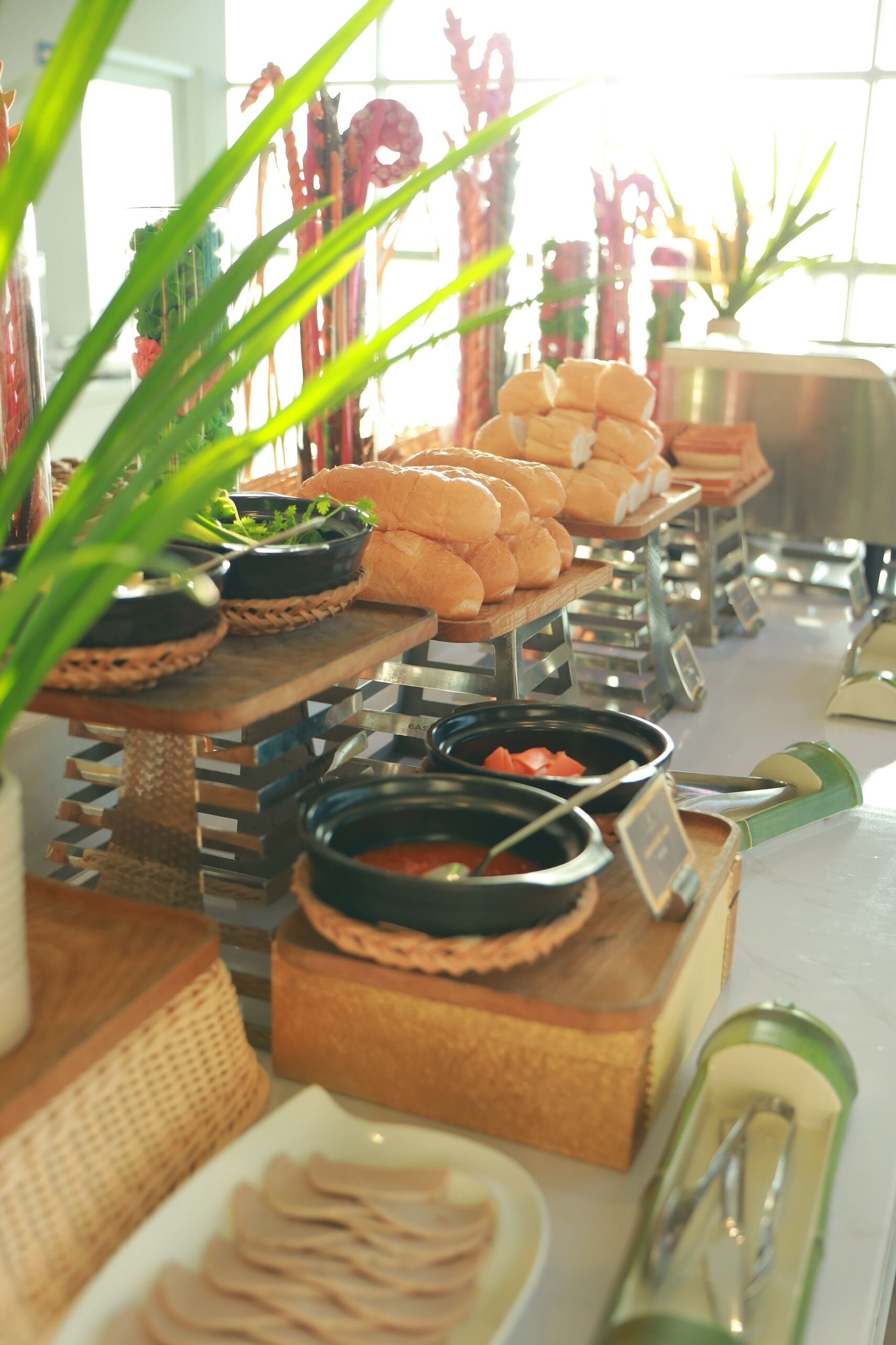 A buffet setup with various food items and condiments.