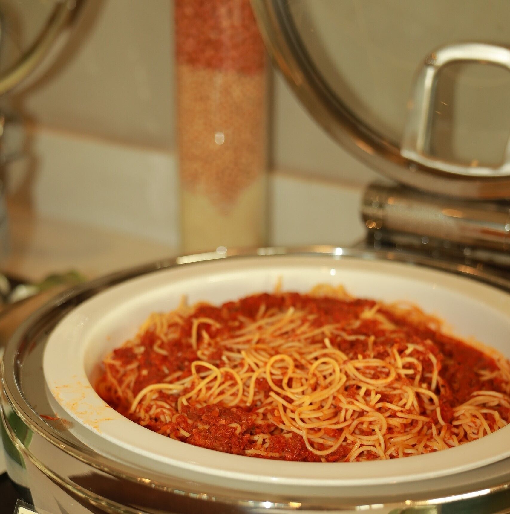 A bowl of spaghetti with tomato sauce.